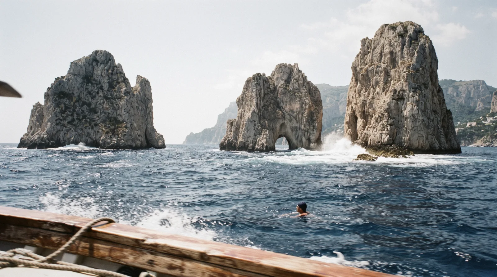 The Faraglioni rock stacks off the south coast of Capri seen from the cliff terraces above Marina Piccola in morning light